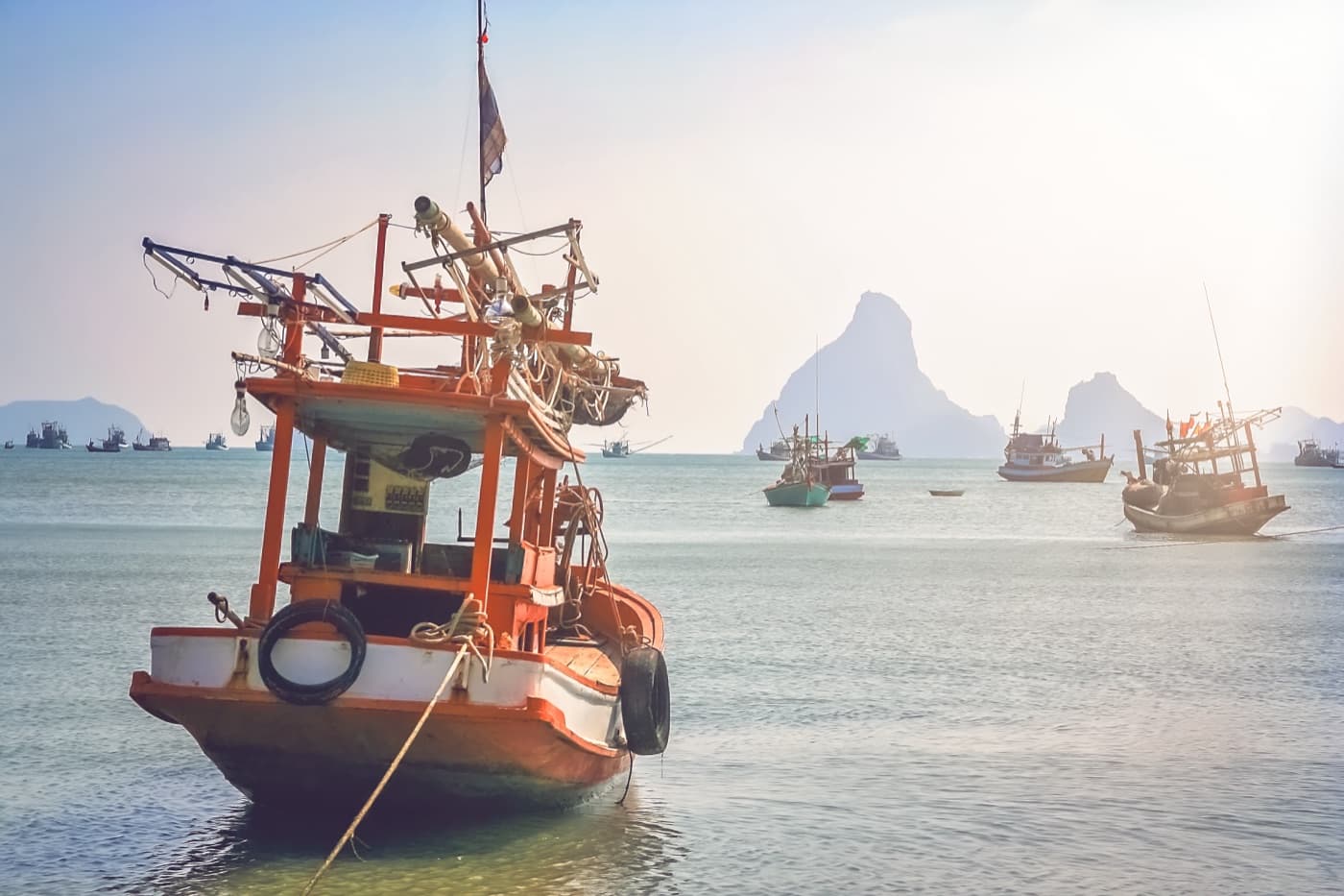 Fishing boats in the Gulf of Thailand under a grey sky