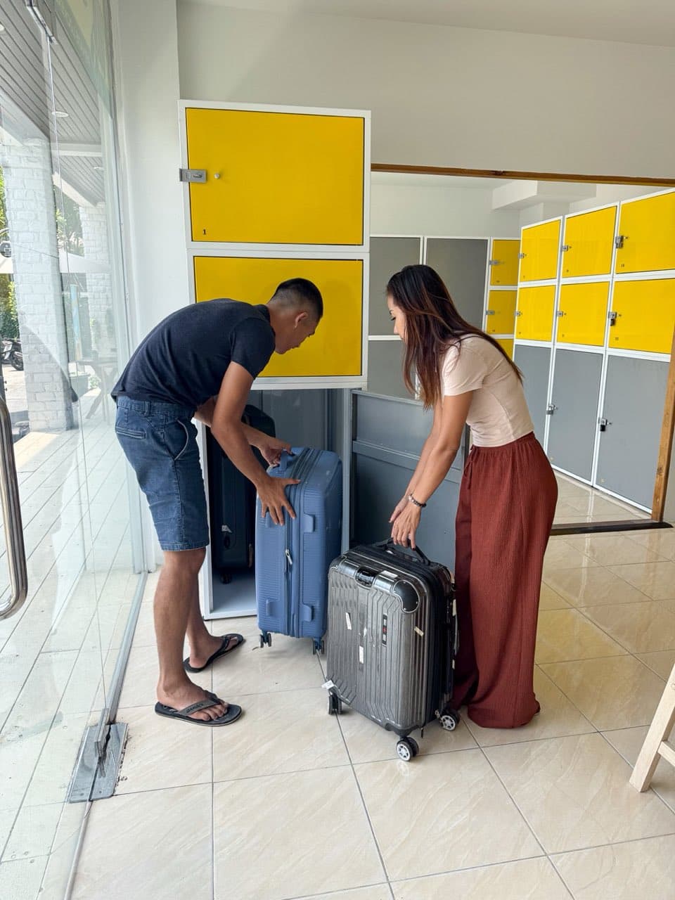Our staff loading a customer's suitcase into a locker